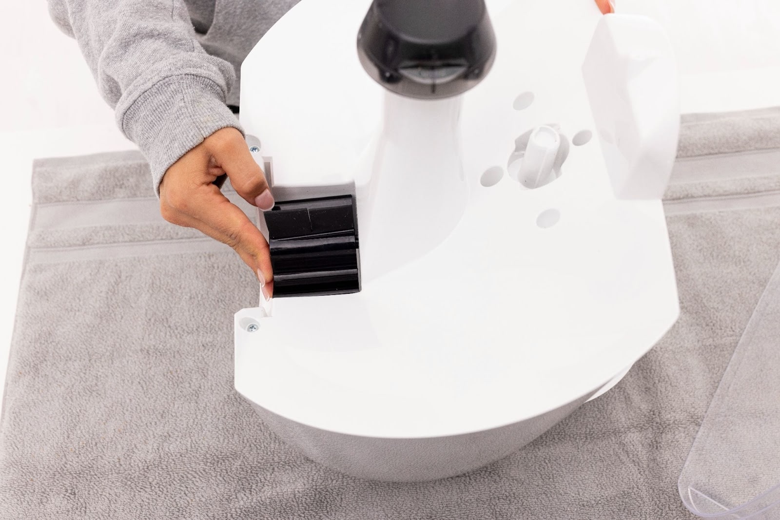 Reinstalling the dispenser, ensuring the text faces out