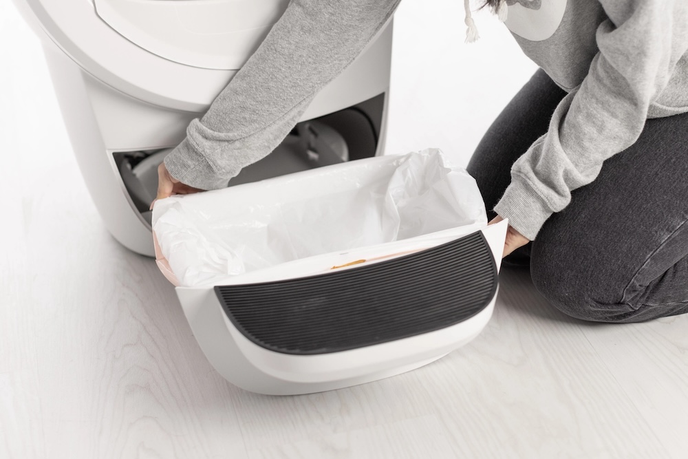 Wrapping the edges of the Litter-Robot 4 Liner over the rim of the waste drawer