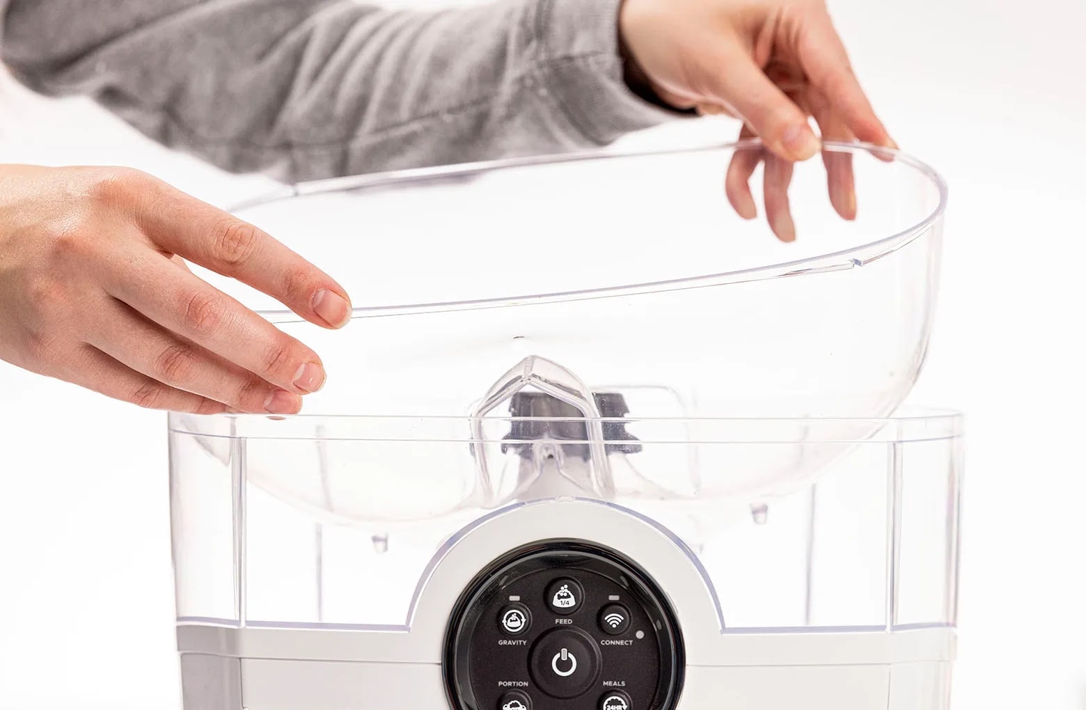 Reinstalling the hopper insert, ensuring the opening faces toward the back of the unit