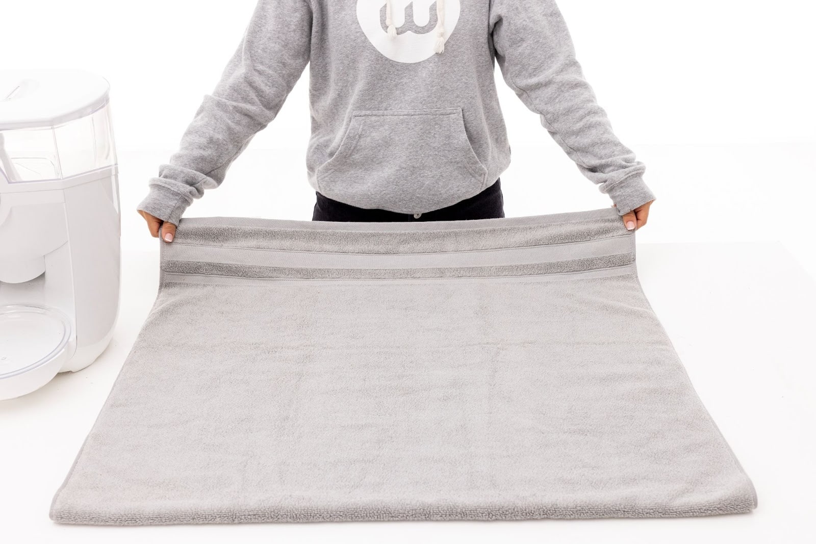 Laying a towel on a flat surface.