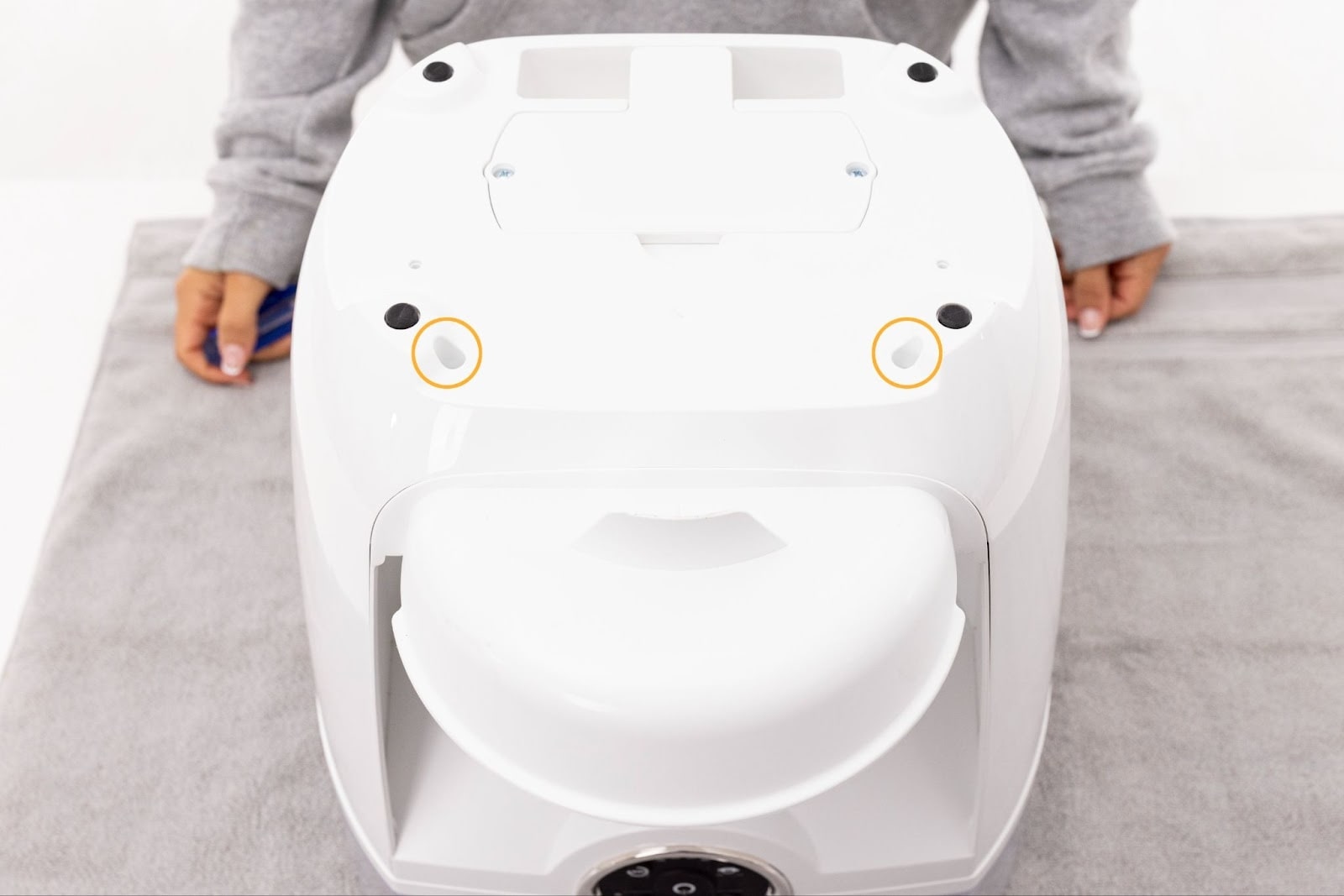 Removing the two screws in the bottom of Feeder-Robot's base.