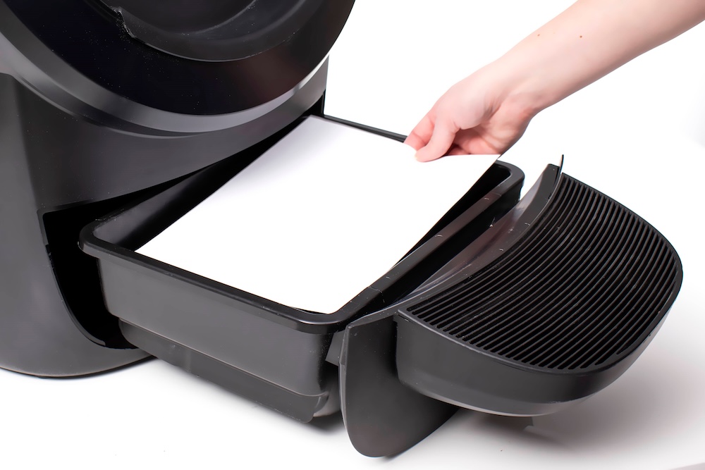 Gray calibration card inside of waste drawer