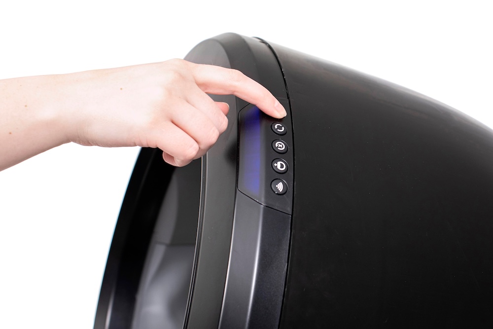 Finger pressing Power button on Litter-Robot 4