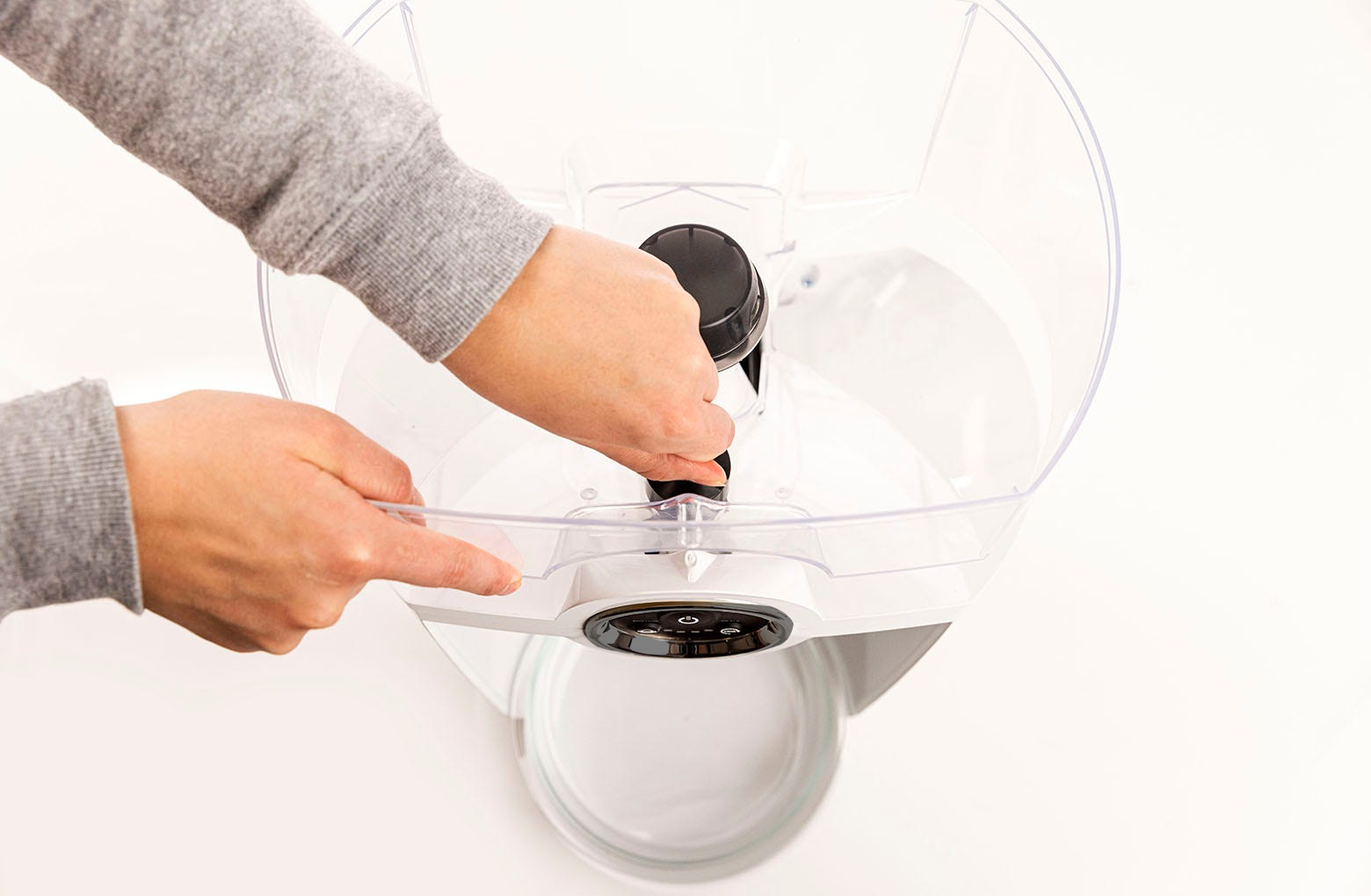 Removing the Feeder-Robot hopper by rotating the hopper lock knob counterclockwise. Lift the hopper away from the base of the unit