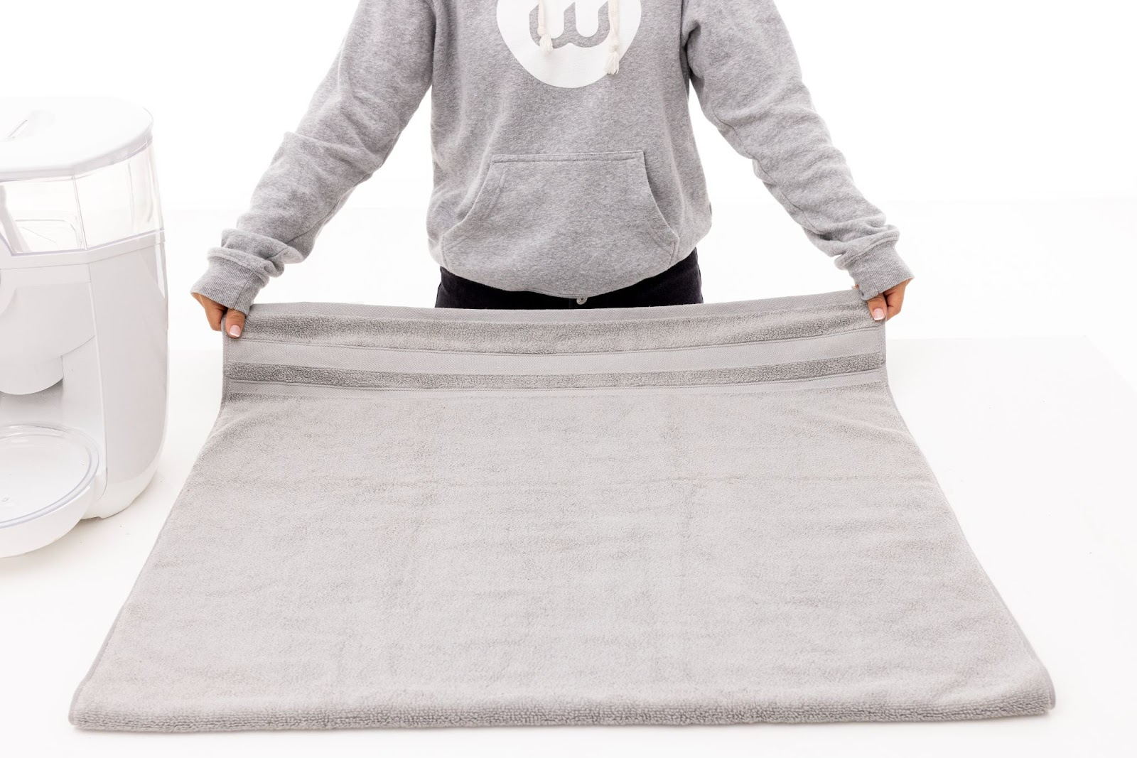 Laying a towel on a flat surface.