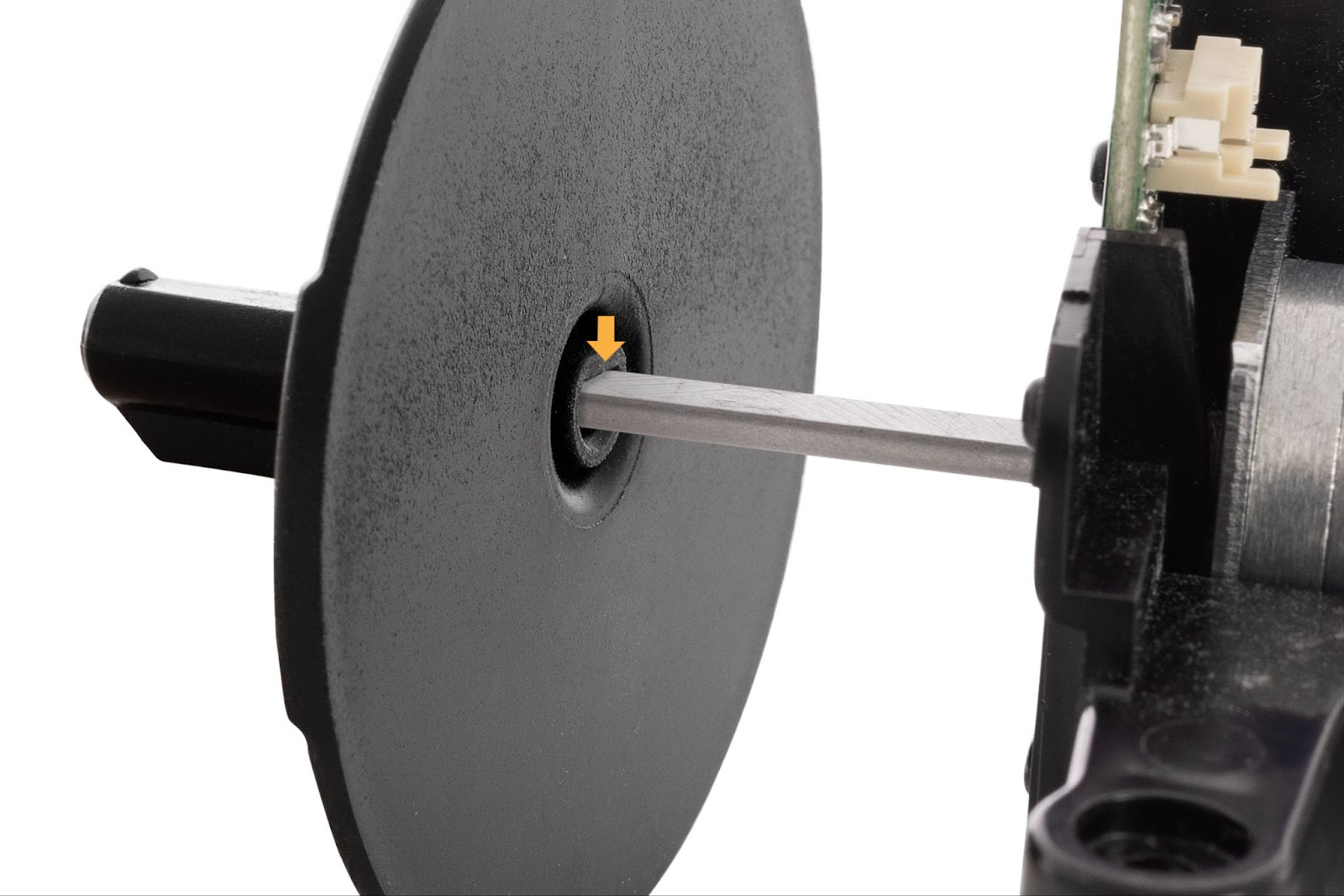 Sliding the black, circular dispenser adapter onto the new motor assembly