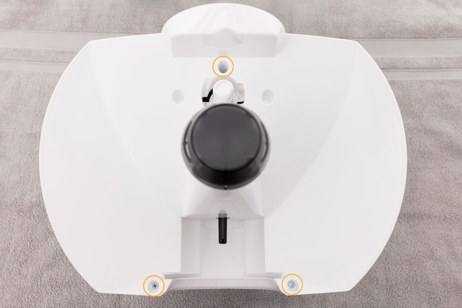 Removing three screws from the top of the base