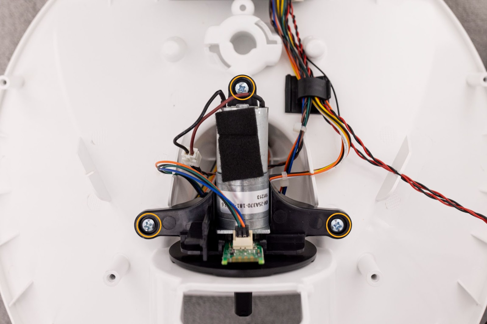 Installing three screws to hold down the motor bracket